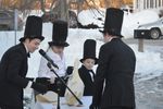 Scramble talks to his handlers, who are wearing top hats